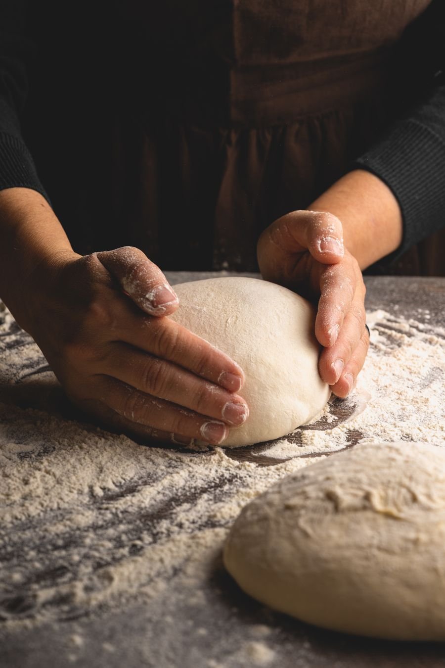 Hands kneading fresh dough